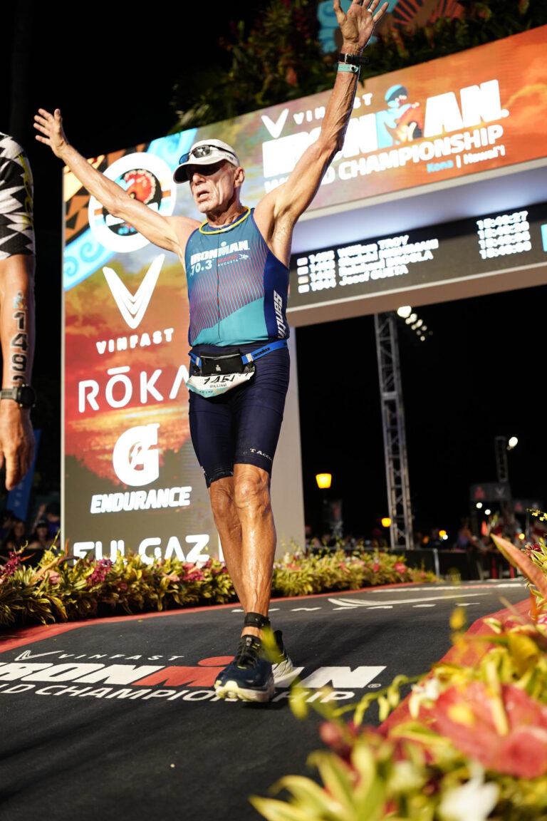 A marathon runner raising his hands